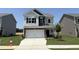 Charming two-story home with white garage, manicured lawn, and classic architectural details at 184 Bruce Dr, Dunn, NC 28334