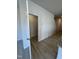 Hallway with wood-look floors, closet, and staircase at 184 Bruce Dr, Dunn, NC 28334