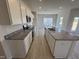 Bright kitchen featuring granite countertops, a kitchen island, and stainless steel appliances at 184 Bruce Dr, Dunn, NC 28334