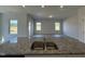 Island sink featuring granite countertops and stainless steel in a light-filled open-concept kitchen at 184 Bruce Dr, Dunn, NC 28334