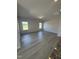 Bright living room with two windows and wood-look flooring at 184 Bruce Dr, Dunn, NC 28334