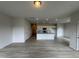 Open-concept living area with light gray wood-look flooring flowing into the kitchen at 184 Bruce Dr, Dunn, NC 28334