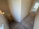 Carpeted staircase descending to lower level of home at 184 Bruce Dr, Dunn, NC 28334