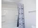 Clean bathroom with a shower-tub combo featuring white tile and a decorative shower curtain at 2121 Wildwind Dr, Graham, NC 27253