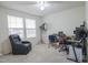 Bright room with large windows, neutral walls and carpet, and an ergonomic gaming chair and desk setup at 2121 Wildwind Dr, Graham, NC 27253