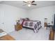 This bedroom features a ceiling fan, a cozy bed, a wooden dresser, and neutral walls and carpet at 2121 Wildwind Dr, Graham, NC 27253