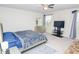 Bright bedroom with a ceiling fan, large windows, a comfortable bed, dresser and TV stand, offers a relaxing space at 2121 Wildwind Dr, Graham, NC 27253