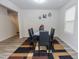 Features a modern dining set with a black table and chairs, complemented by a stylish, colorful geometric rug at 2121 Wildwind Dr, Graham, NC 27253