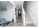Bright entryway showcasing wood-look flooring, stairs to the upper level, and neutral paint at 2121 Wildwind Dr, Graham, NC 27253