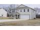 Beautiful two-story home boasting a two-car garage, a lovely covered porch, and a well-maintained lawn at 2121 Wildwind Dr, Graham, NC 27253