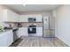 Well-lit kitchen with stainless steel appliances, white cabinets, granite counters, and decorative backsplash at 2121 Wildwind Dr, Graham, NC 27253