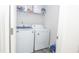 Convenient laundry room equipped with a washer and dryer and ample shelving space for storage at 2121 Wildwind Dr, Graham, NC 27253