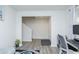 Neutral living room with gray vinyl floors and white walls leading to staircase with a work-from-home space nearby at 2121 Wildwind Dr, Graham, NC 27253