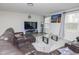 Inviting living room features a plush brown sectional, a glass-top coffee table, and a large-screen TV at 2121 Wildwind Dr, Graham, NC 27253