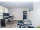 Well-lit home office with wood-look floors, a modern desk setup, and a comfortable seating area at 2121 Wildwind Dr, Graham, NC 27253