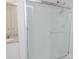 Bathroom features a glass enclosed shower, wood-look tile floors, granite countertop and white cabinets at 2121 Wildwind Dr, Graham, NC 27253