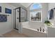 Bright bathroom features a soaking tub under a window with a black framed shower at 22 Old York Cir, Clayton, NC 27527
