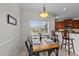 Inviting dining area features a bright window, stylish lighting, and seating for four, perfect for intimate gatherings at 22 Old York Cir, Clayton, NC 27527