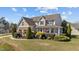 Lovely two-story home featuring a welcoming front porch, beautiful landscaping, and classic architectural details at 22 Old York Cir, Clayton, NC 27527