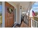 Charming front porch with a rocking chair, an American flag, and a decorative wreath on the front door at 22 Old York Cir, Clayton, NC 27527