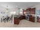 Well-appointed kitchen featuring dark wood cabinets, tile floors, and stainless steel appliances adjoining dining area at 22 Old York Cir, Clayton, NC 27527