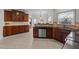 Spacious kitchen featuring custom wood cabinets, tile floors, granite countertops, and modern stainless steel appliances at 22 Old York Cir, Clayton, NC 27527