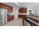Spacious kitchen featuring custom wood cabinets, tile floors, granite countertops, and stainless steel appliances at 22 Old York Cir, Clayton, NC 27527