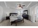 Spacious main bedroom with tray ceilings, a ceiling fan, ample natural light, and a full furniture set at 22 Old York Cir, Clayton, NC 27527