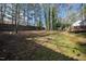 Picture of a spacious, grassy backyard surrounded by mature trees, providing a private outdoor area at 224 Round About Rd, Holly Springs, NC 27540