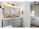 Bright bathroom featuring a double vanity, modern lighting, and clean design at 224 Round About Rd, Holly Springs, NC 27540