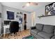 Cozy bedroom featuring a workspace, grey sofa, and Penn State decor at 224 Round About Rd, Holly Springs, NC 27540