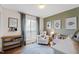 Charming Bedroom with a rocking chair, crib, and natural light at 224 Round About Rd, Holly Springs, NC 27540