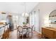 Cozy dining area featuring a modern chandelier and an adjacent kitchen for easy entertaining at 224 Round About Rd, Holly Springs, NC 27540
