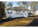 Charming home featuring a cozy front porch with lovely hanging floral arrangements and manicured landscaping at 224 Round About Rd, Holly Springs, NC 27540