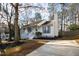 Quaint home with a welcoming front porch, freshly mulched landscaping, and a well-maintained exterior at 224 Round About Rd, Holly Springs, NC 27540