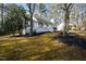 Attractive home nestled amongst mature trees, featuring a charming front porch and well-kept lawn at 224 Round About Rd, Holly Springs, NC 27540