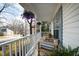 Inviting front porch with comfortable seating, potted plants, and charming floral decorations at 224 Round About Rd, Holly Springs, NC 27540