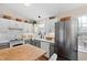 Updated kitchen with white cabinets, marble countertops, stainless steel refrigerator at 224 Round About Rd, Holly Springs, NC 27540