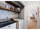 Laundry room with storage shelving, modern washer, and a dryer at 224 Round About Rd, Holly Springs, NC 27540