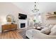 Comfortable living room with a decorative fireplace and mantel, lots of natural light, and neutral tones at 224 Round About Rd, Holly Springs, NC 27540