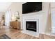 Cozy living room with fireplace, television, wood floors, and stylish decorations at 224 Round About Rd, Holly Springs, NC 27540