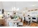 Bright living space featuring an open layout to the kitchen, a vaulted ceiling, and stylish furnishings at 224 Round About Rd, Holly Springs, NC 27540