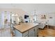 Open-concept space with island kitchen, dining area, fireplace, and comfortable living room at 224 Round About Rd, Holly Springs, NC 27540