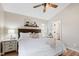 Serene main bedroom with a ceiling fan, bedside lamps, and soft decor at 224 Round About Rd, Holly Springs, NC 27540
