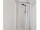 Clean shower with a rainfall showerhead and modern curtain design at 224 Round About Rd, Holly Springs, NC 27540