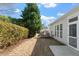 The backyard is landscaped with mature trees and shrubs, a patio, and a lawn at 241 Lifeson Way, Cary, NC 27519
