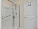 Modern bathroom features a glass enclosed shower with a handheld shower head and grab bars at 241 Lifeson Way, Cary, NC 27519