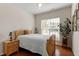 Bedroom with wood floors, a ceiling fan, a bed, and a bright window view at 241 Lifeson Way, Cary, NC 27519