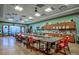 Bright craft room with multiple tables, storage cabinets, and ample natural light at 241 Lifeson Way, Cary, NC 27519