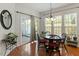 Bright dining area with a slider door to the patio and complete with a modern chandelier at 241 Lifeson Way, Cary, NC 27519